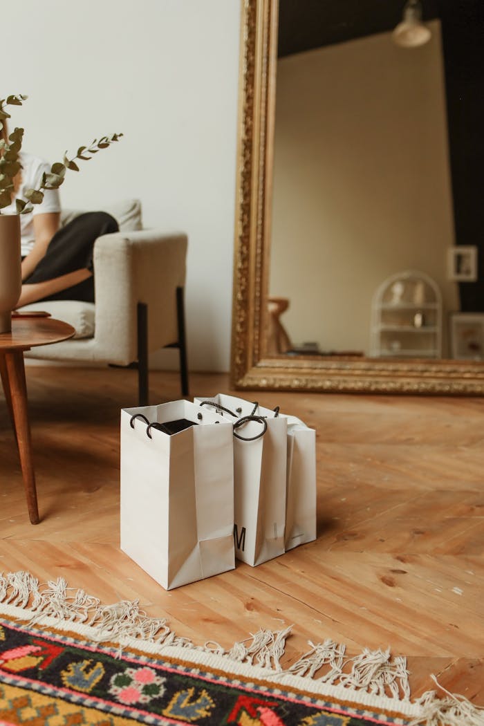 The Art of Drawing Readers In: Your attractive post title goes here Modern living room with shopping bags and a large ornate mirror reflecting the decor.